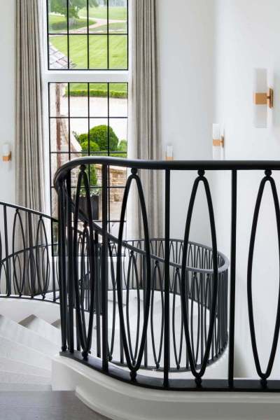 River Song Haven - Curved Staircase and Iron Rail Detail – Castle Homes