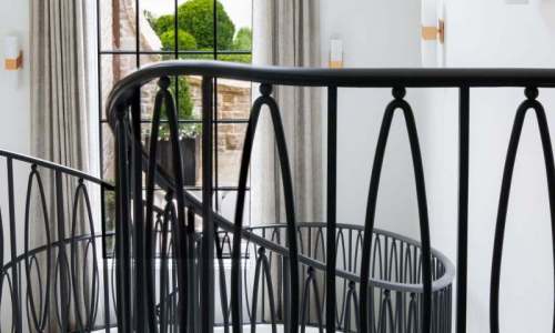 River Song Haven - Curved Staircase and Iron Rail Detail – Castle Homes