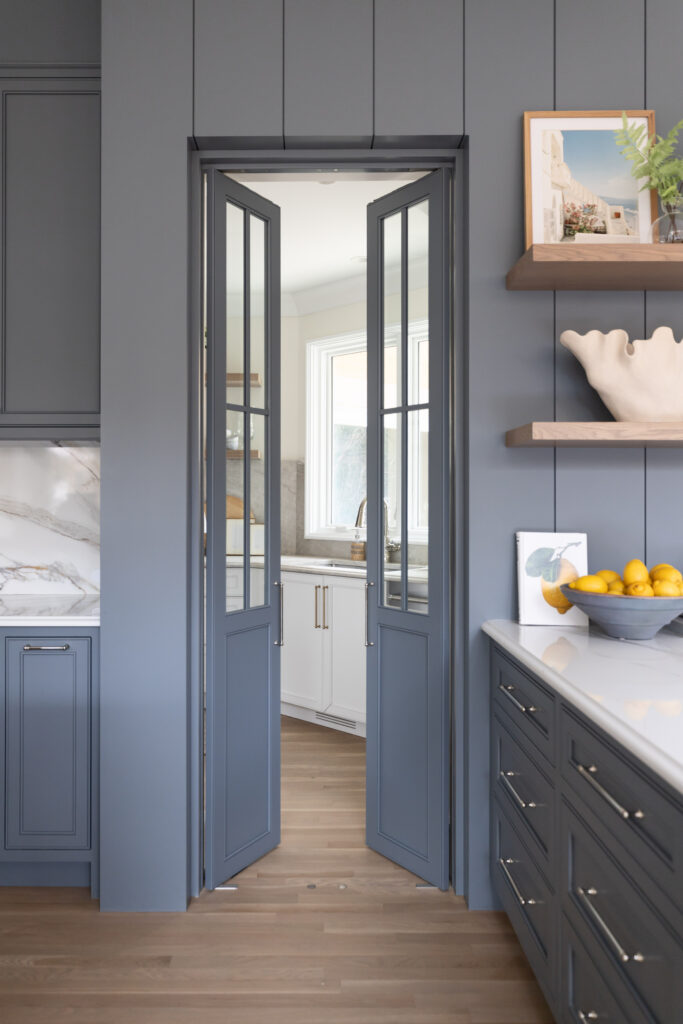 Custom butler's pantry with glass-paneled doors, designer cabinetry and luxury kitchen detailing in a custom-built home.
